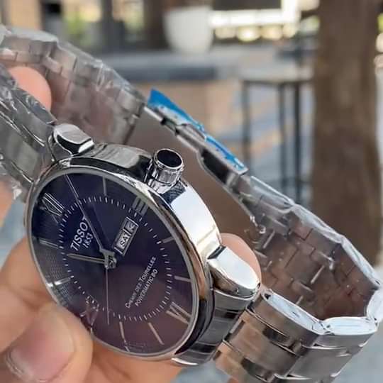 ساعة Tissot Stainless Steel Day-Date لون سيلفر ومطعم ميناء اسود وابيض