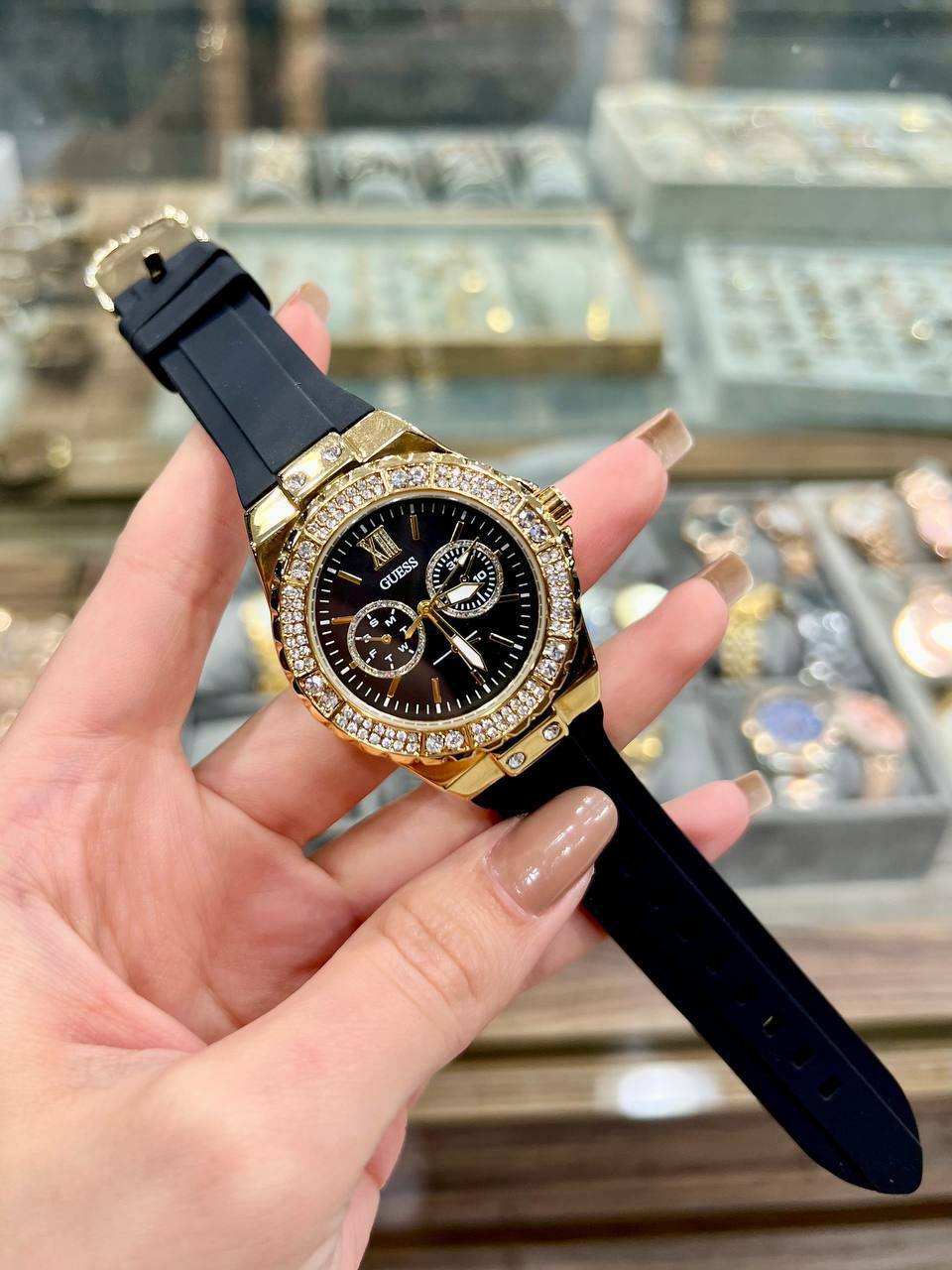 ساعة Guess Women’s Black Rubber Strap – Gold Crystal Bezel 