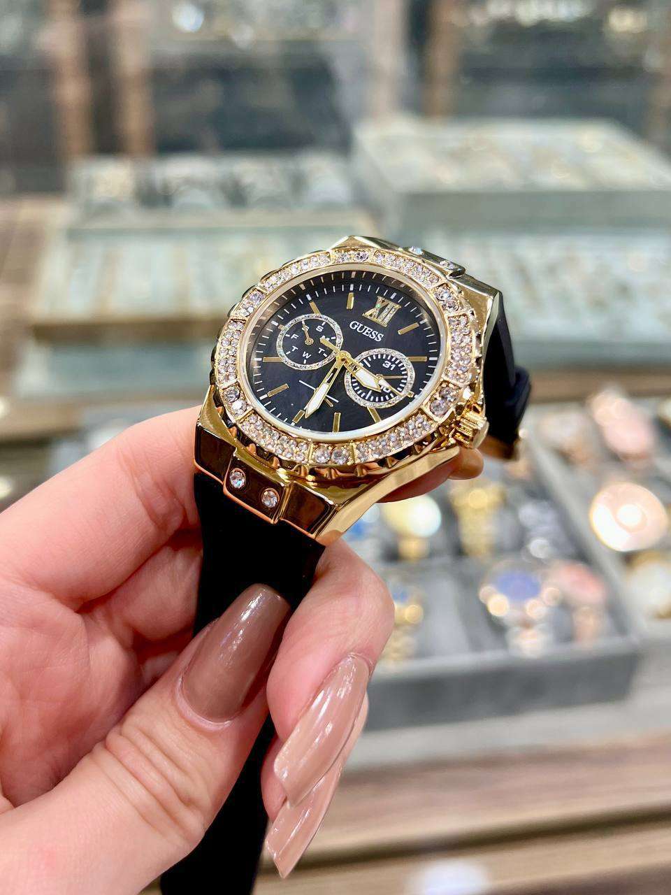ساعة Guess Women’s Black Rubber Strap – Gold Crystal Bezel 