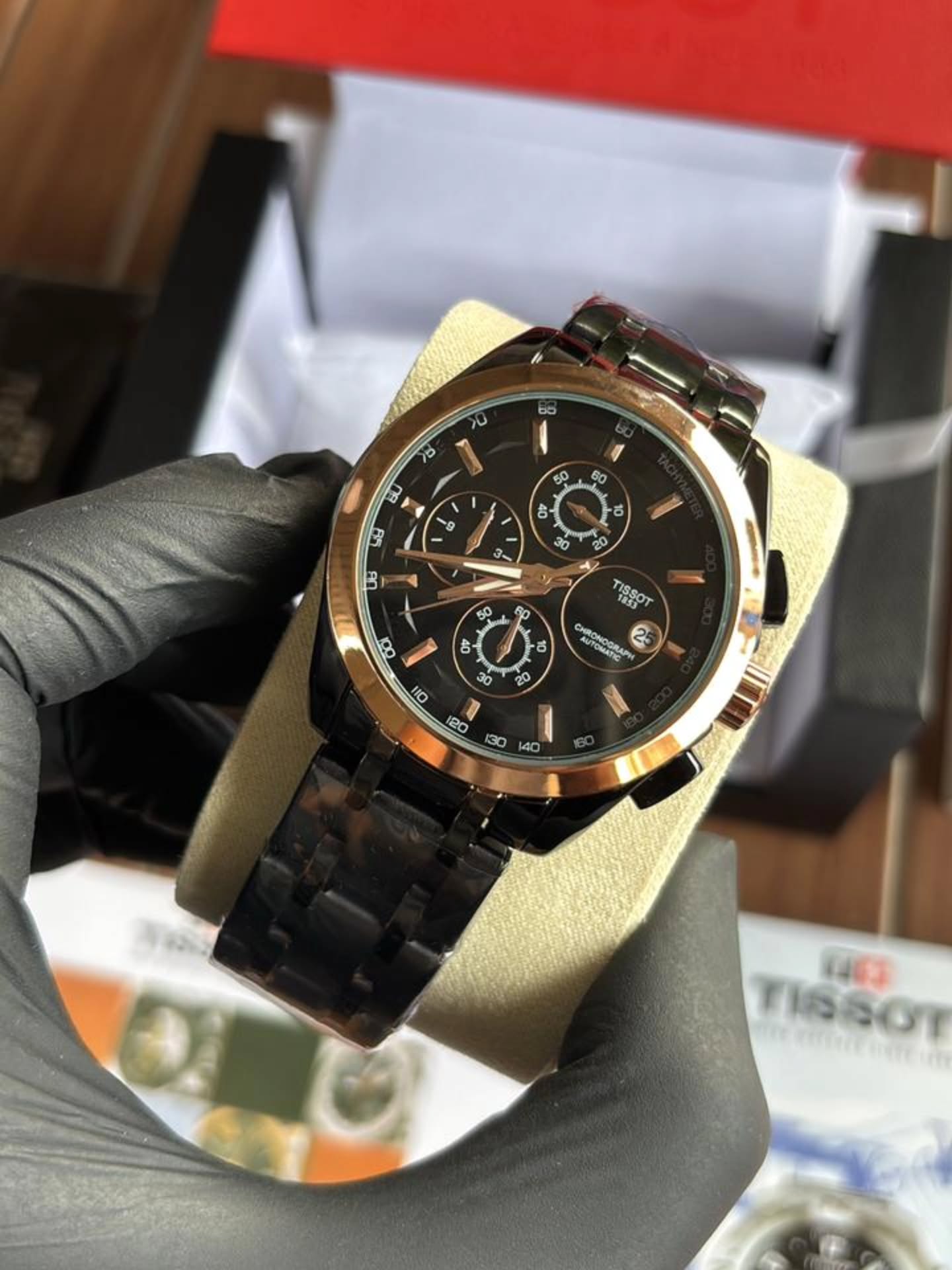 ساعة Tissot Chronograph Watch – Black Dial, Rose Gold Bezel & Black Metal Bracelet لون اسود اطار روز جولد عدادات تعمل 